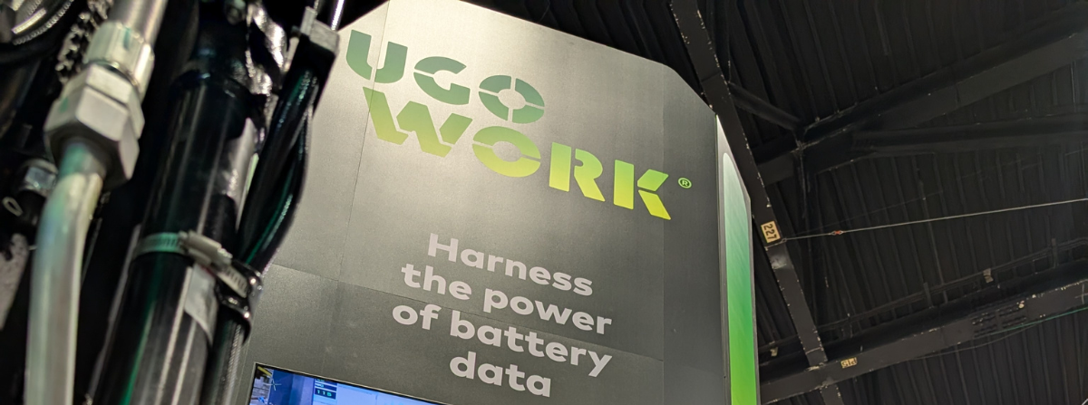 UgoWork trade show booth display with the slogan “Harness the power of battery data” beneath the green UgoWork logo.