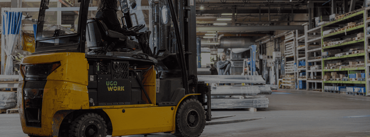 Forklift powered with UgoWork battery, driving in warehouse.