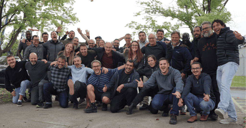 A group photo of the UgoWork team, all smiling with festive expressions, gathered together for a celebratory moment.