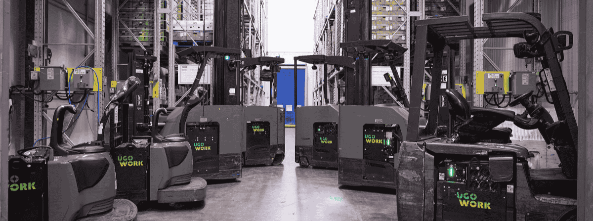 Material handling equipment equipped with UgoWork batteries, neatly aligned in a refrigerated warehouse.