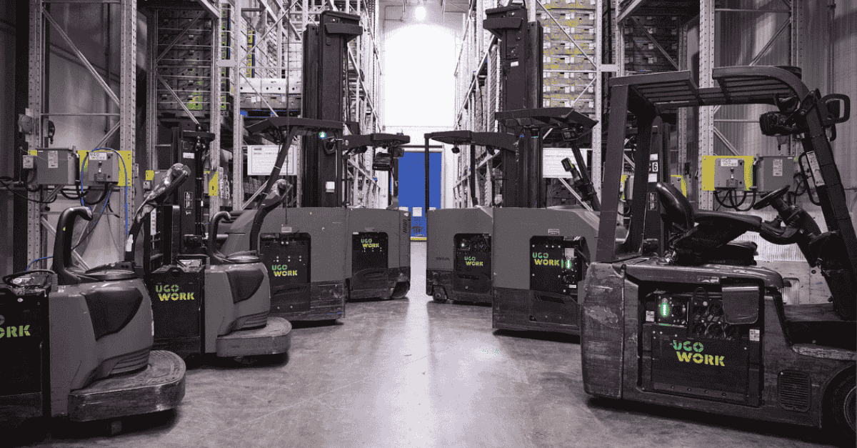 Material handling equipment equipped with UgoWork batteries, neatly aligned in a refrigerated warehouse.