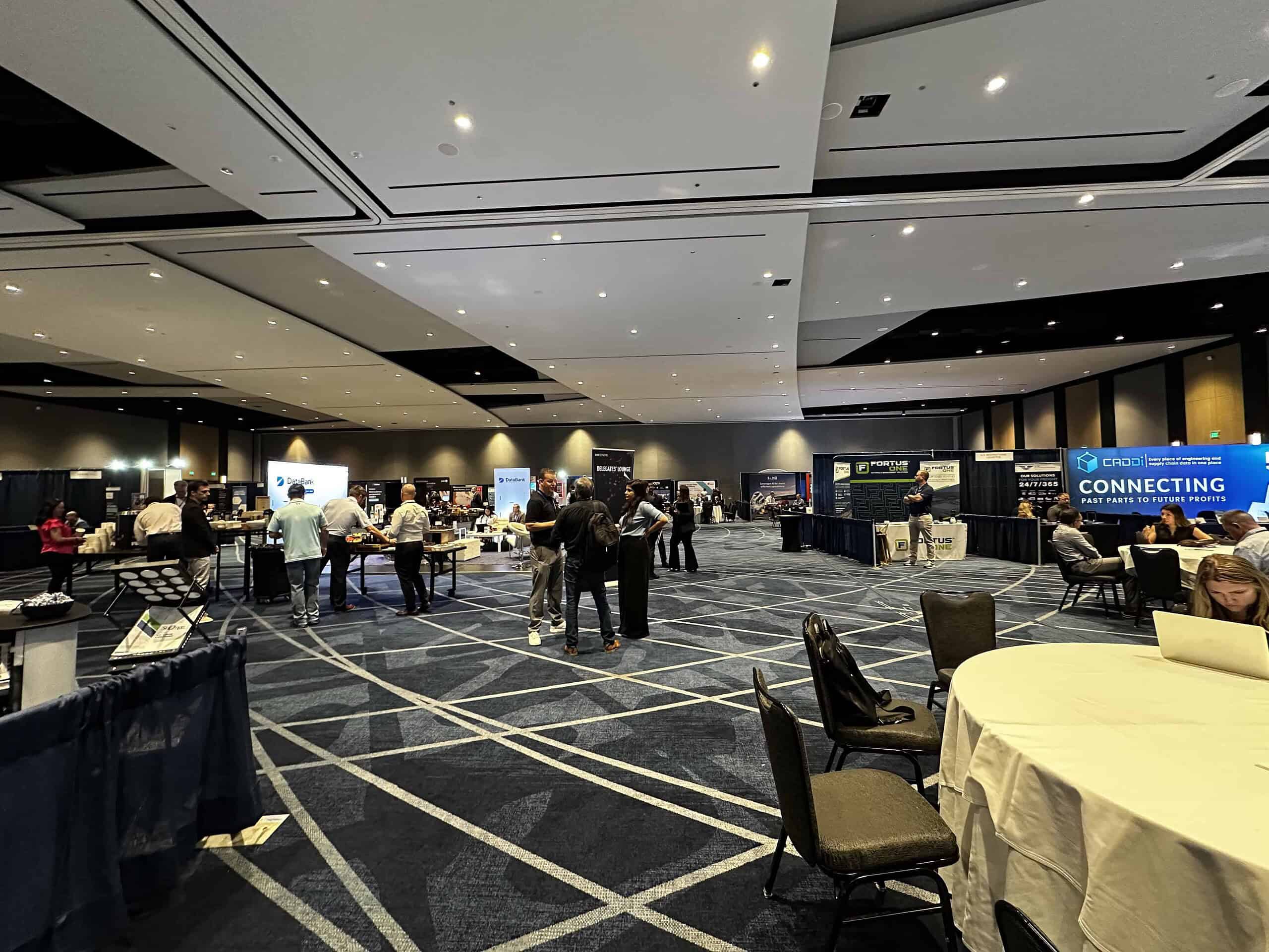 Exhibitor booths and networking area at the American Supply Chain Summit.
