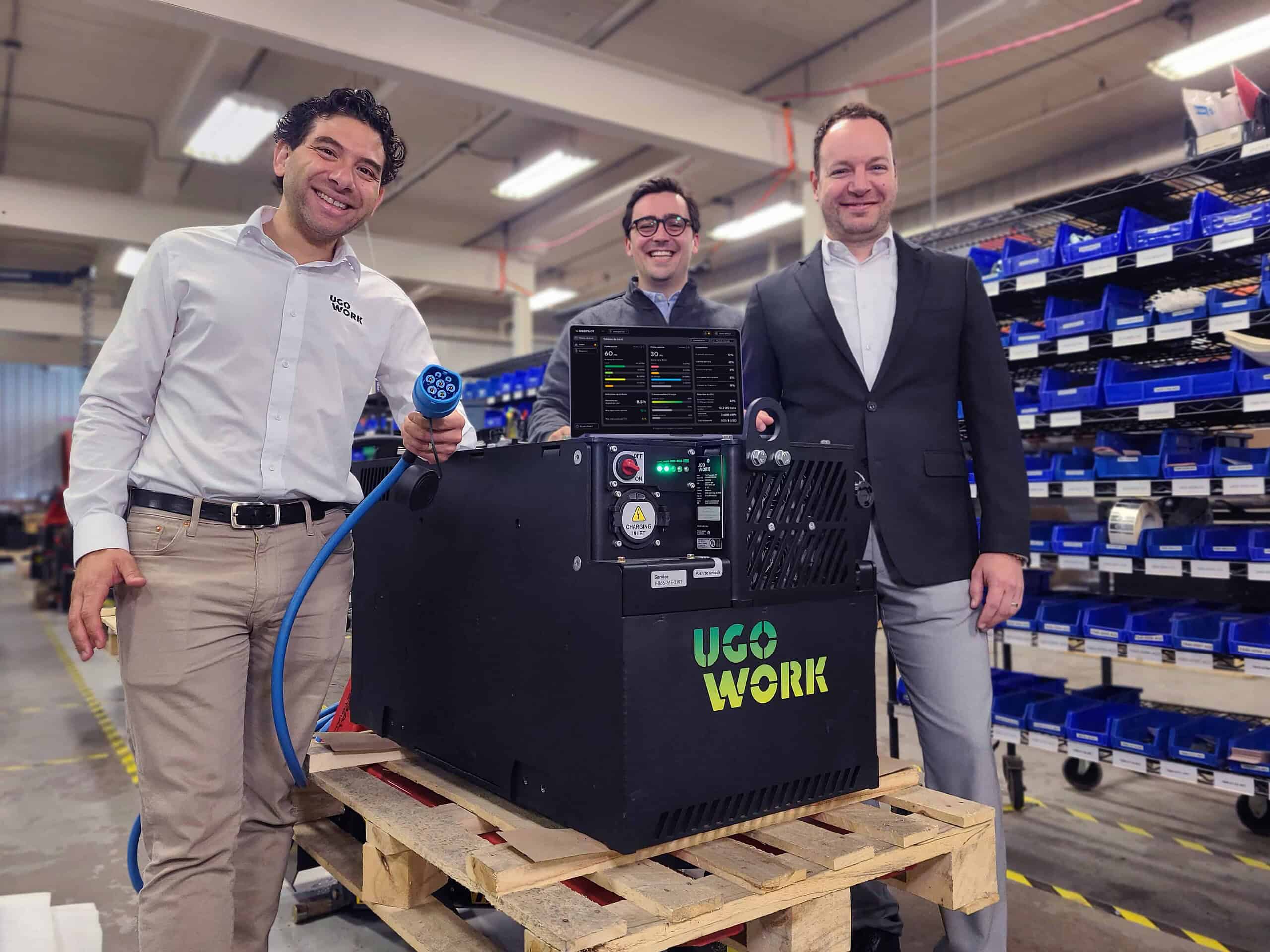 3 businessmen in front a lithium-ion battery and a computer showing a monitoring software
