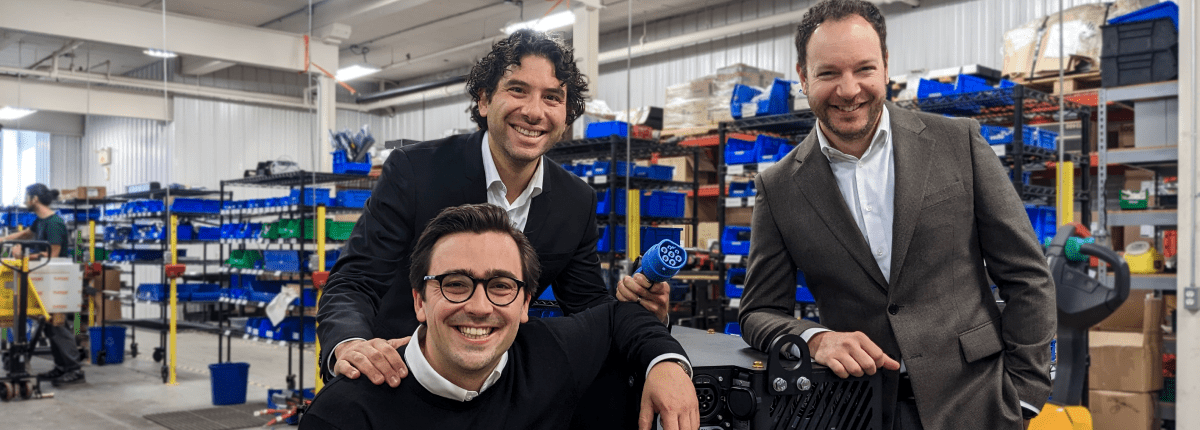 3 businessmen in front a lithium-ion battery