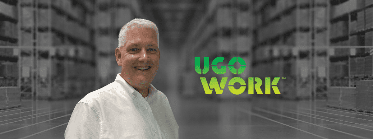 Sales man posing in front of a warehouse background