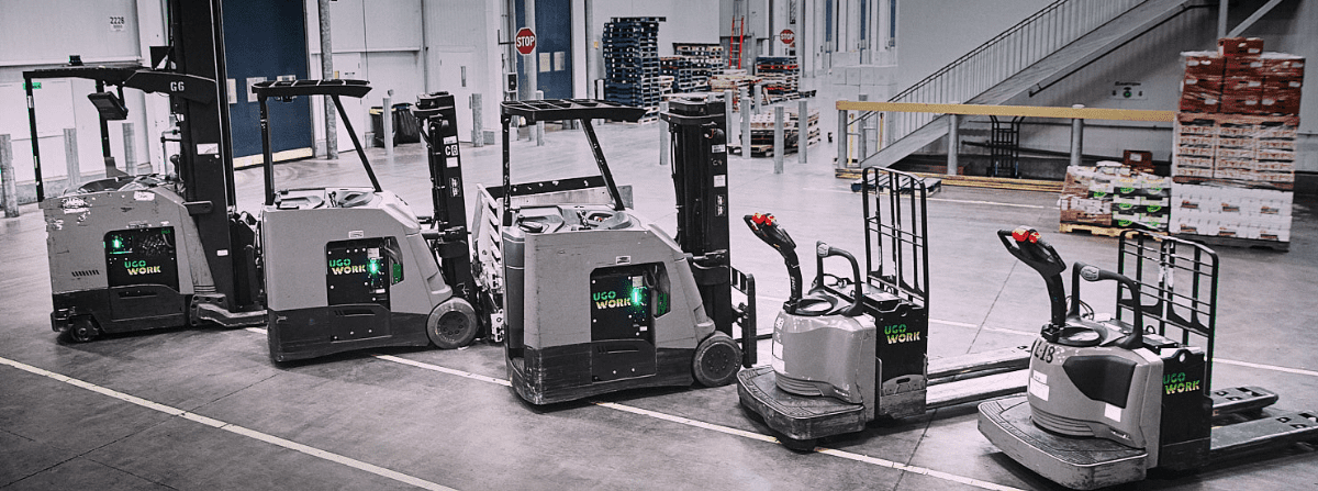 Reach trucks and forklifts lined up in a refrigerated warehouse