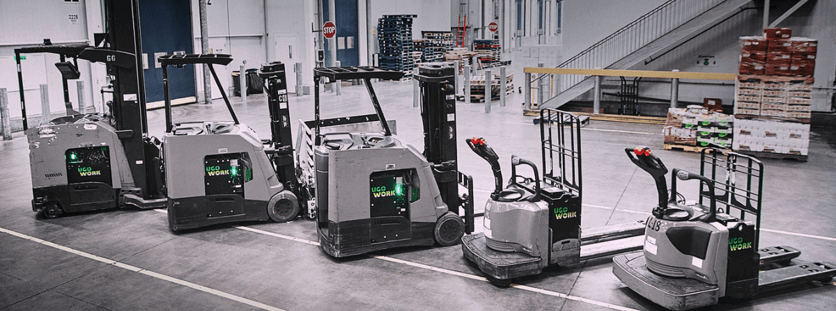 Electric forklifts lined-up in a warehouse