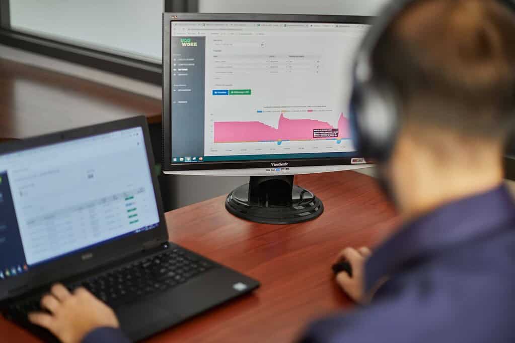 Data analyst looking at fleet data, metrics and KPI dashboard on computer screen