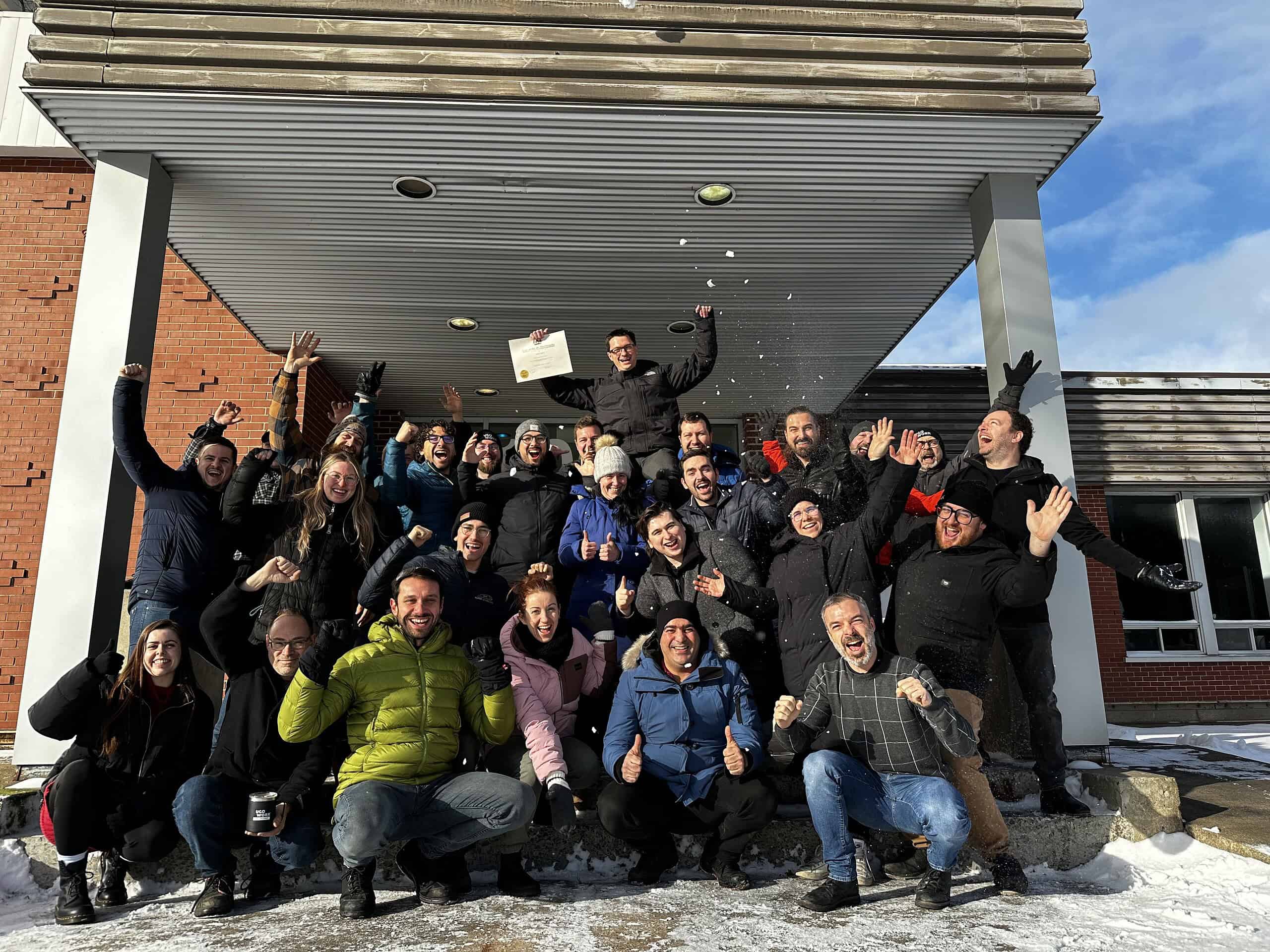 Enjoying a team celebration outside UgoWork office in snowy weather, showcasing team spirit and success.