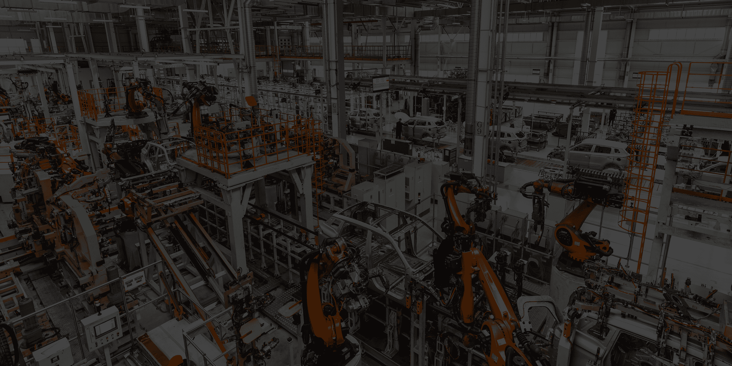 Robots and industrial equipment in a car manufacturing plant.